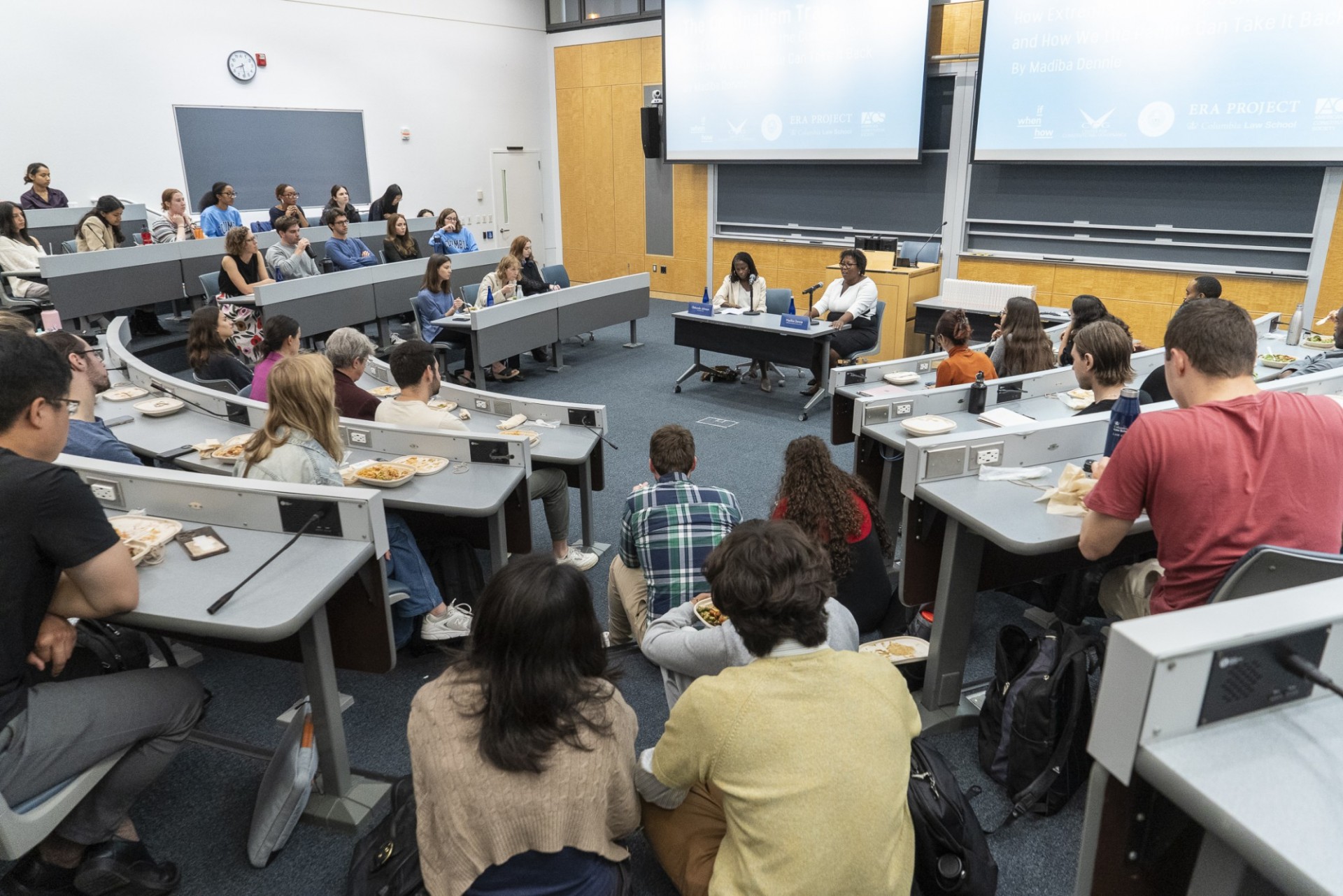 Student in classroom listening to Olatunde Johnson and Madiba Dennie panel