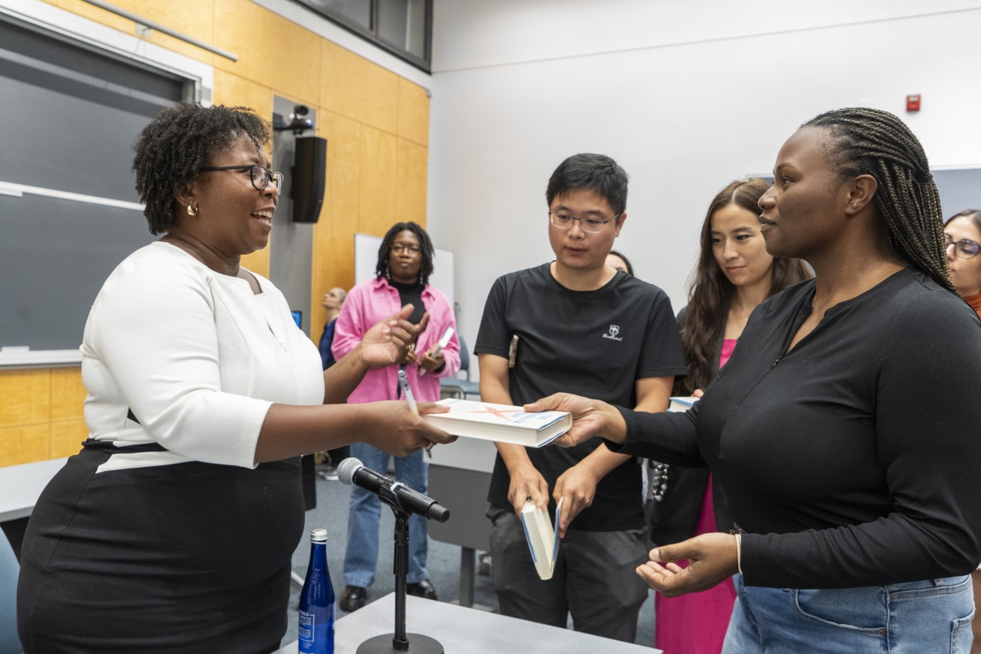 Madiba Dennie signing book for Columbia Law Student